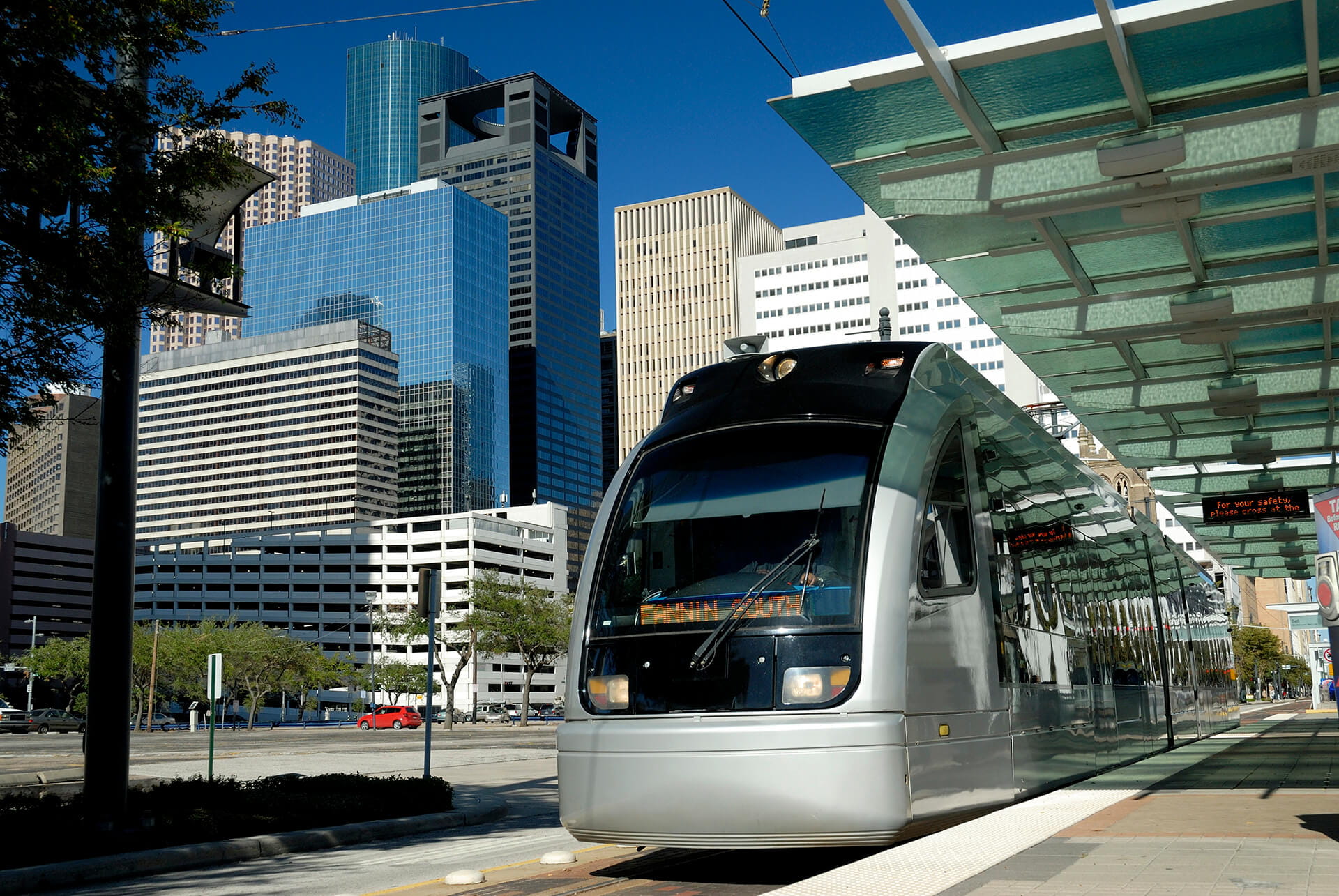 Metro Train at Platform With Modern Skyscrapers In Background